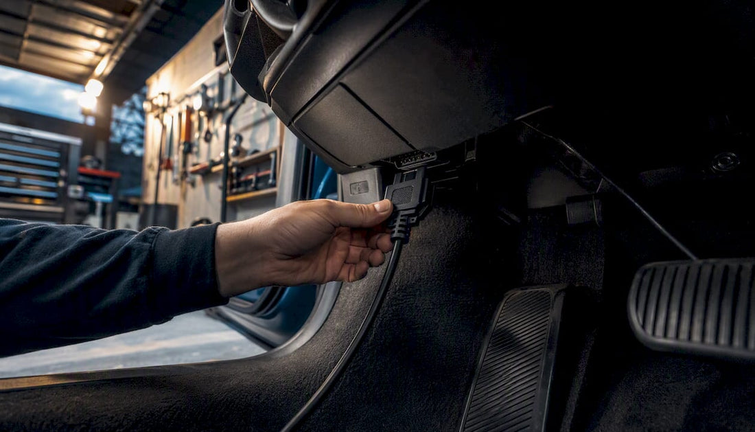 Technician connecting battery service tool to vehicle