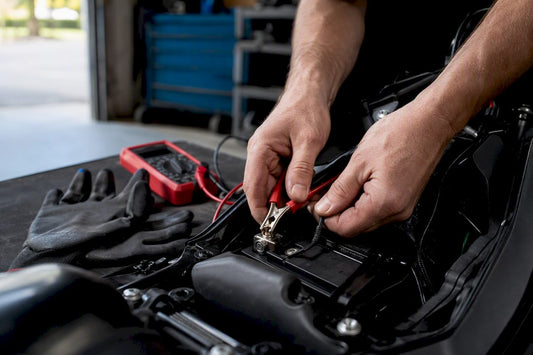 Hands connecting trickle charger to battery