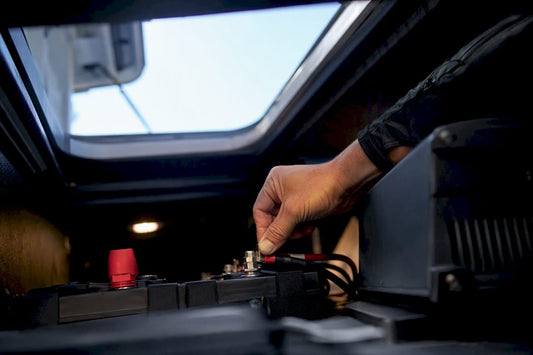 Marine battery charging connections in boat compartment