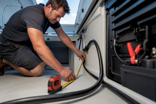 Technician measuring marine battery cable route