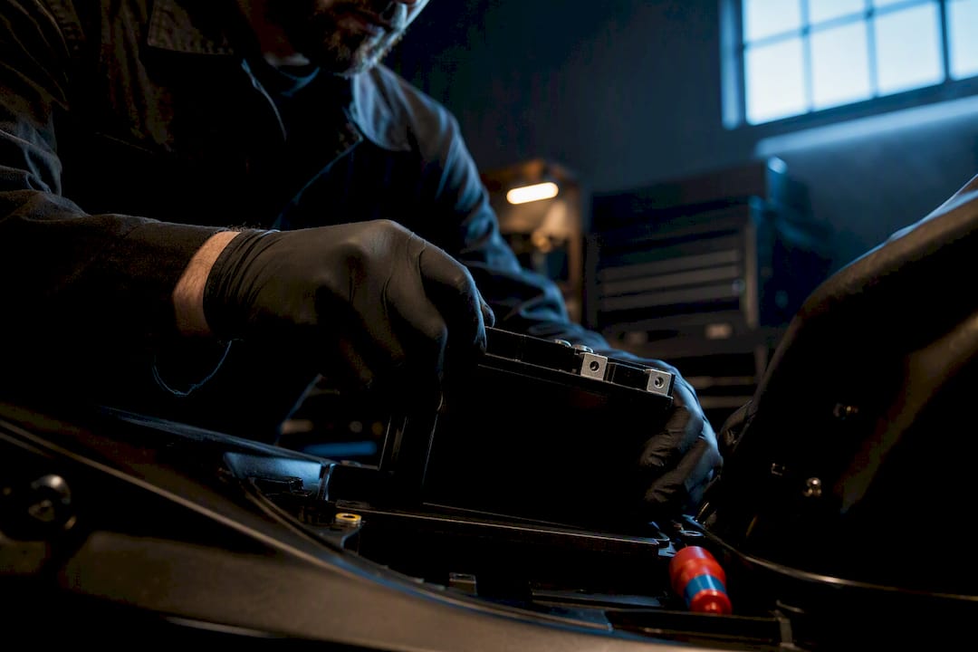 Technician replacing a motorcycle battery