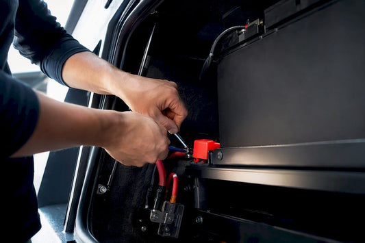 Truck auxiliary battery installation in utility bay
