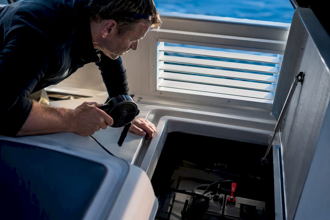 Boat owner ventilating engine compartment before jump start